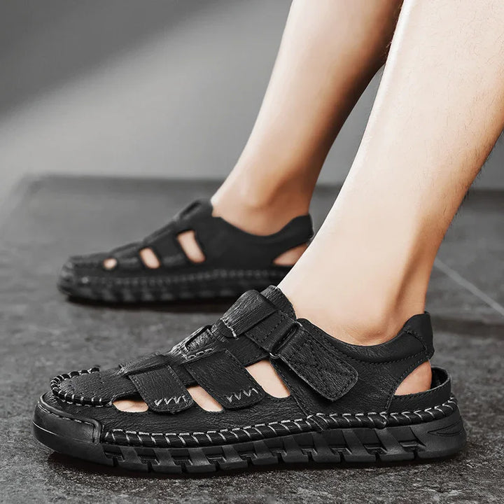 Men's black leather outdoor sandals with adjustable straps on tiled floor