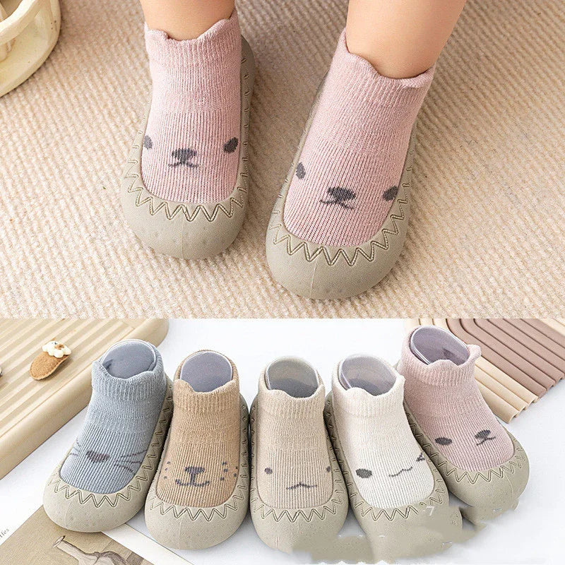Soft baby socks with non-slip rubber soles in pastel colors and cute animal faces
