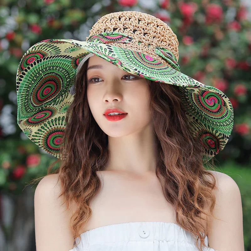 Young woman with wavy hair wearing a wide-brimmed green patterned sun hat and white strapless top outdoors