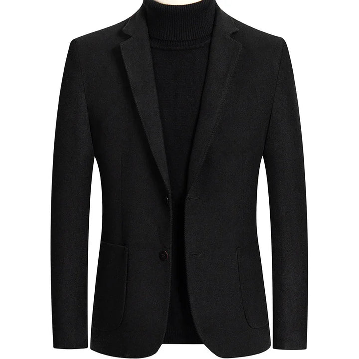 Black men's blazer with notch lapels and front pockets over a black turtleneck sweater
