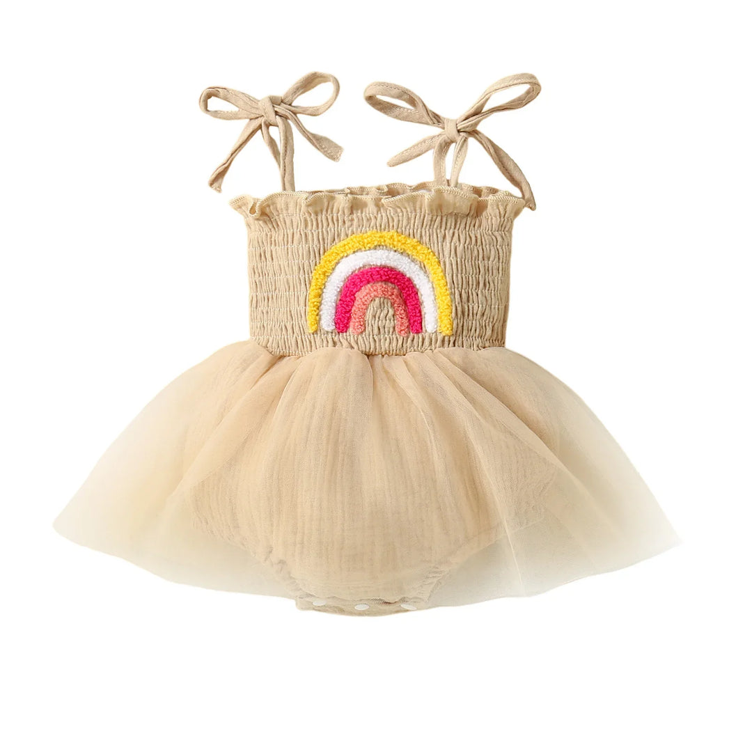 Beige baby dress with tulle skirt and colorful embroidered rainbow on smocked bodice with shoulder ties