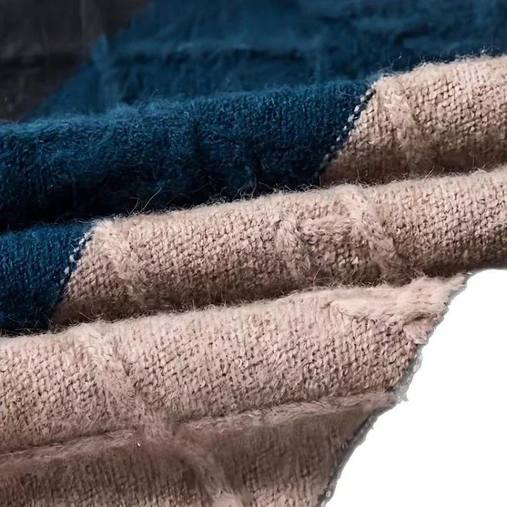 Close-up of soft knit blankets in beige and navy blue with textured, cozy yarn fabric