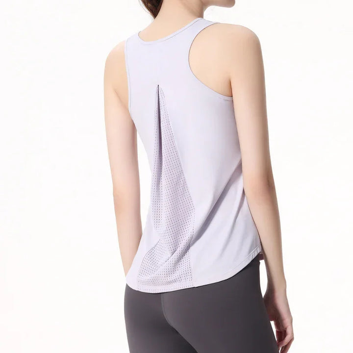 Woman wearing a light purple racerback workout tank top with mesh back panel