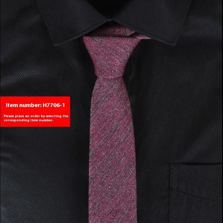 Close-up of red textured necktie on black dress shirt with pointed collar