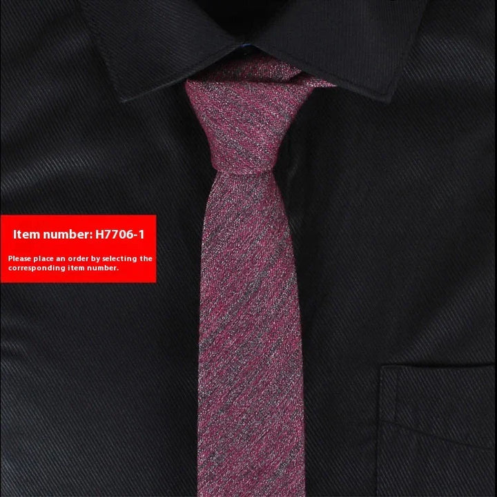 Close-up of red textured necktie on black dress shirt with pointed collar