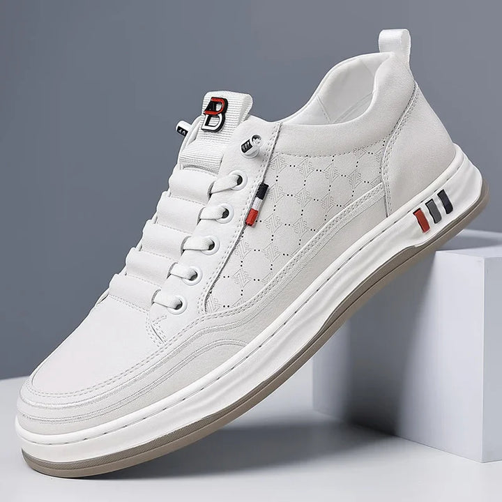 white casual sneaker with patterned side panel, padded tongue with red and black logo, and rubber sole