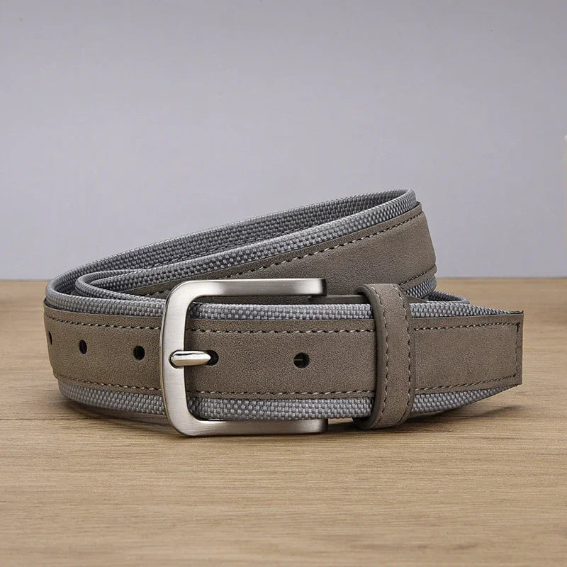Gray suede and fabric men's belt with silver metal buckle on wooden surface