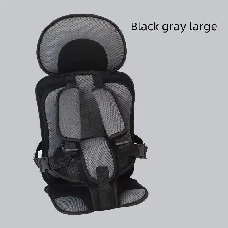 Black and gray large child safety harness seat with padded straps on gray background