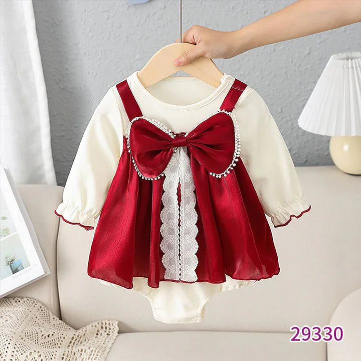 Baby girl cream bodysuit with long sleeves and red satin dress featuring large bow and lace detail