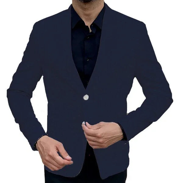 Man wearing a fitted navy blue blazer with a single silver button over a black shirt