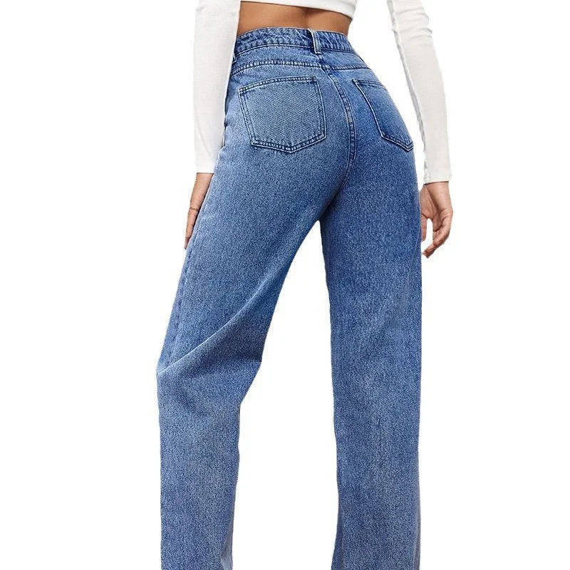 Back view of woman wearing high-waisted blue denim jeans and white crop top