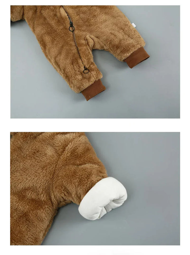 Close-up of brown fuzzy baby romper with zipper and cuff details on grey background