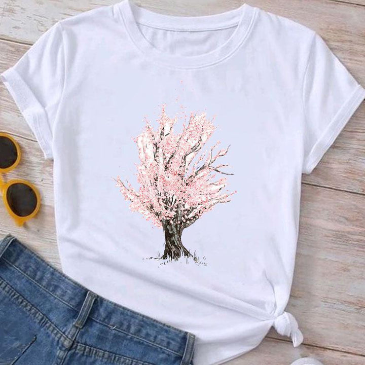 White T-shirt with pink cherry blossom tree graphic paired with denim jeans and yellow sunglasses