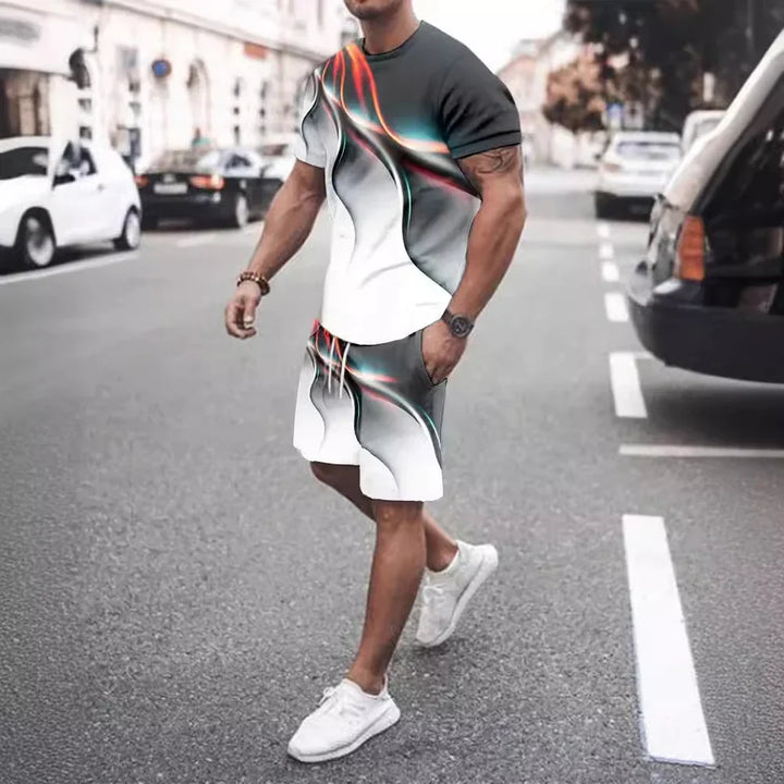 Man wearing black, white, and red abstract print casual t-shirt and shorts walking on urban street