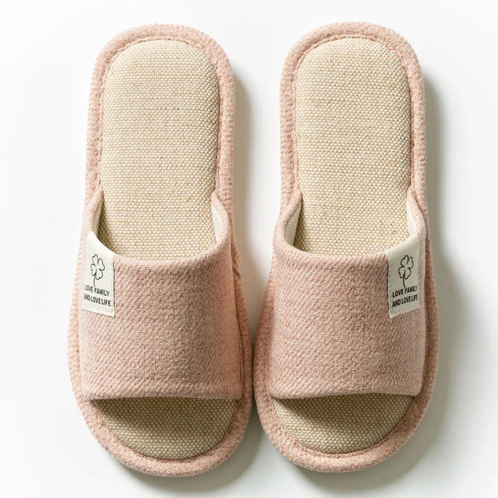 Pink open-toe house slippers with fabric label saying love family and love life