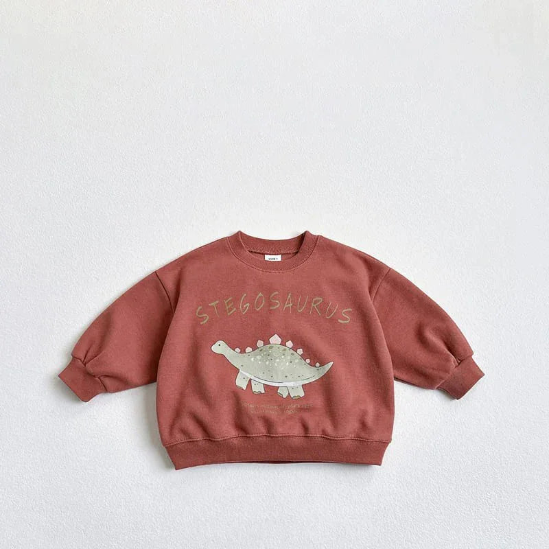 Rust-colored kids sweatshirt with a green Stegosaurus dinosaur graphic and text on front