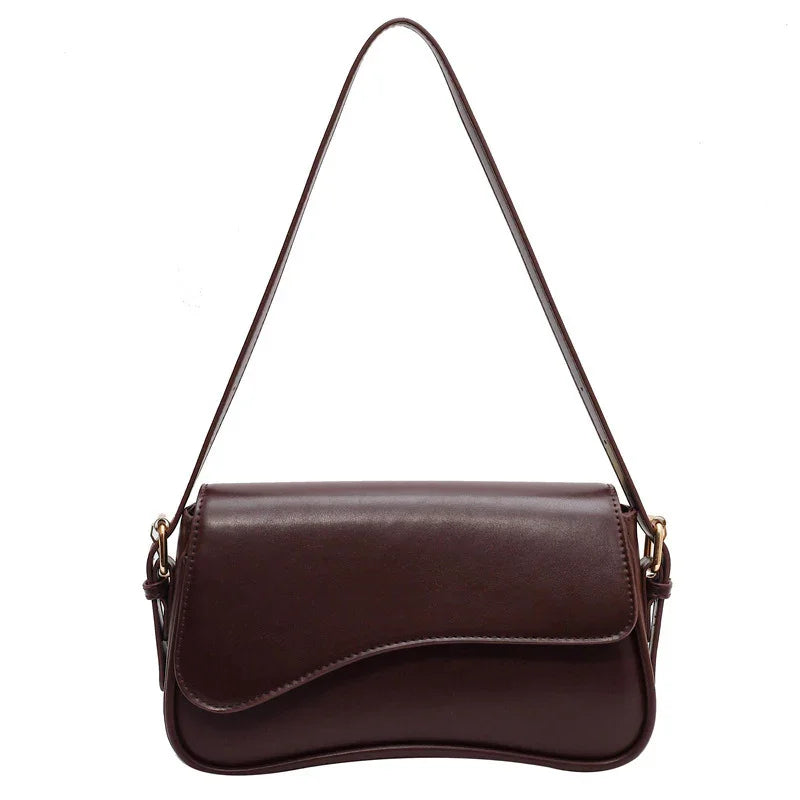 Brown leather shoulder handbag with curved flap and gold-tone hardware
