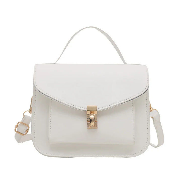 White leather handbag with top handle, front pocket, and gold-tone clasp and strap hardware