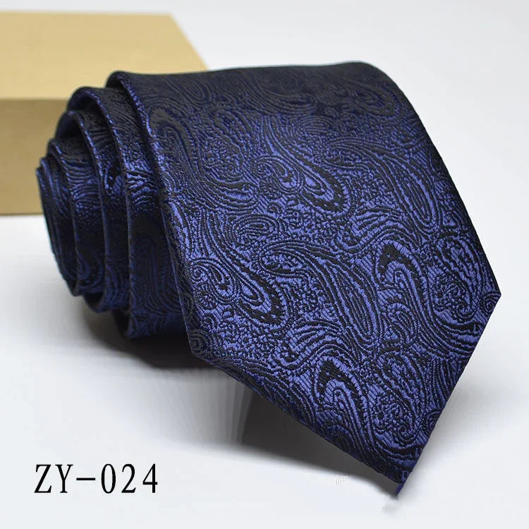 Rolled navy blue paisley patterned men's necktie on white background with product code ZY-024