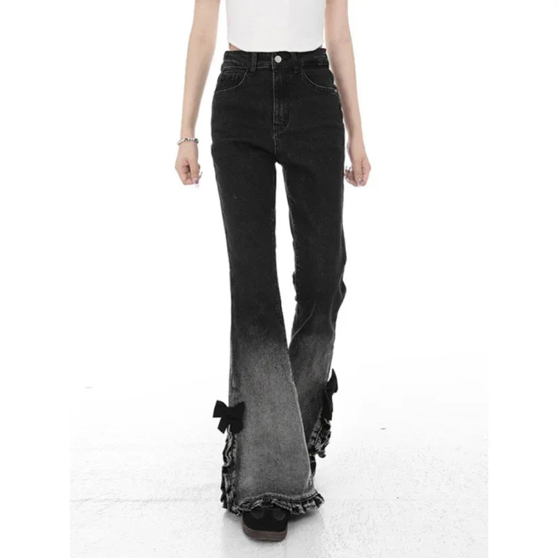Woman wearing high-waisted black ombre flare jeans with ruffled hems and black bows