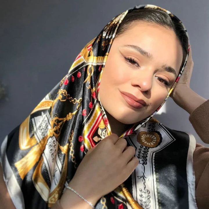 Portrait of a woman wearing a colorful patterned silk scarf with gold, red, and black details