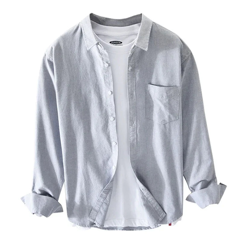 Light grey casual button-up shirt layered over white t-shirt with rolled sleeves