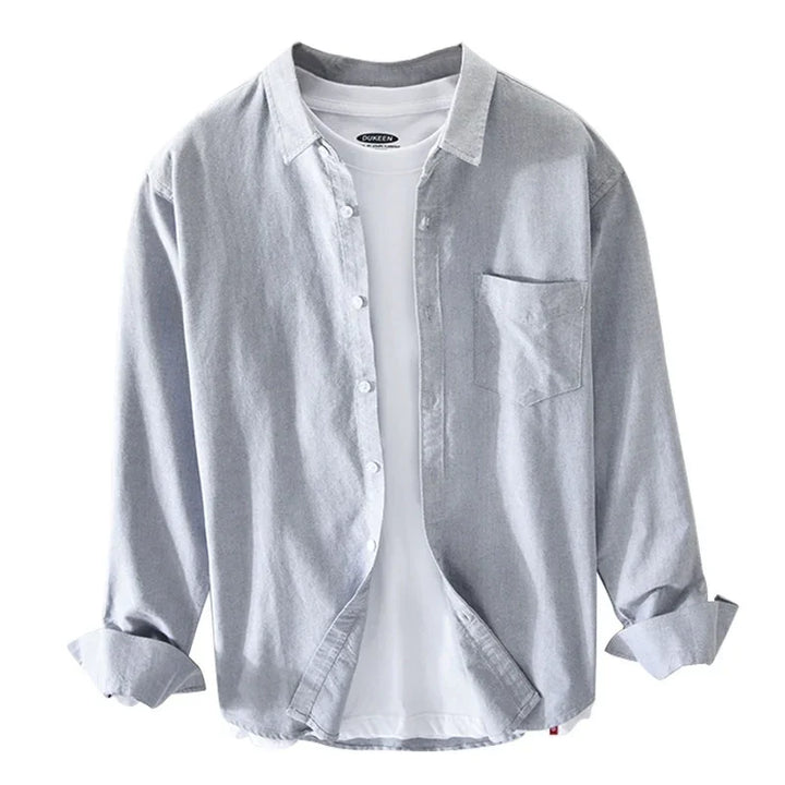 Light grey casual button-up shirt layered over white t-shirt with rolled sleeves