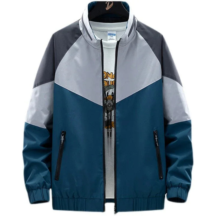 Men's color-block windbreaker jacket with blue, gray, and dark gray panels, front zipper and pockets
