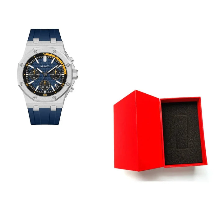 Blue strap silver chronograph wristwatch with yellow accents beside open red watch box with black foam insert