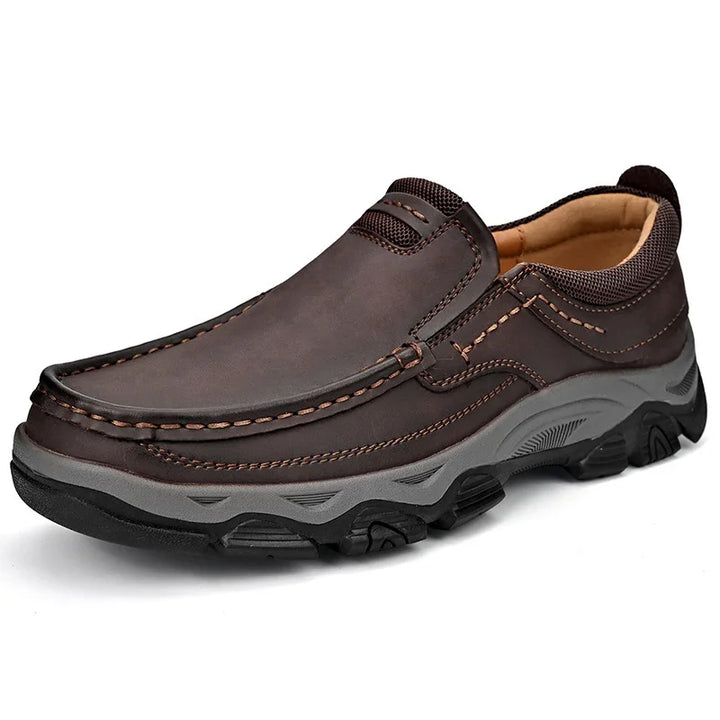 Brown leather slip-on casual men's shoe with detailed stitching and rugged black and gray sole