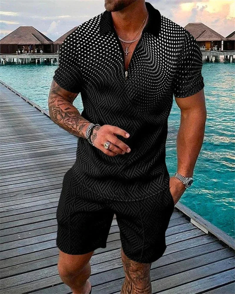 Muscular man wearing black patterned short-sleeve shirt and shorts, standing on wooden pier by turquoise water and overwater bungalows