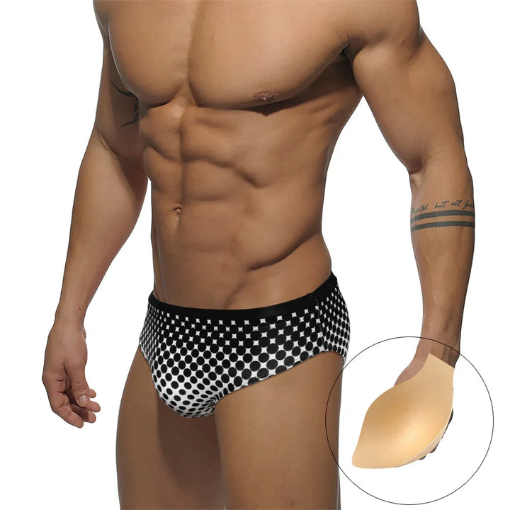 Muscular man wearing black and white polka dot briefs with padded crotch insert shown