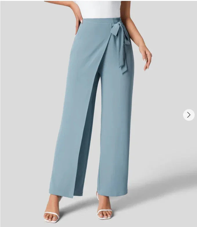 Women's light blue wide-leg pants with wrap front and waist tie, styled with white heels
