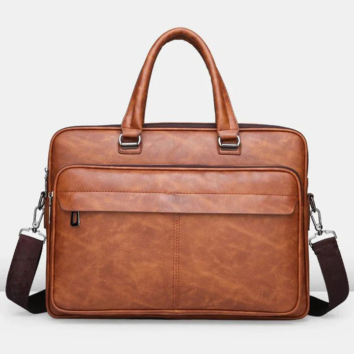 brown leather briefcase with top handles and detachable shoulder strap on white background