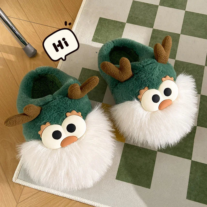 Green plush slippers with cartoon reindeer faces and white fluffy beards on green checkered rug