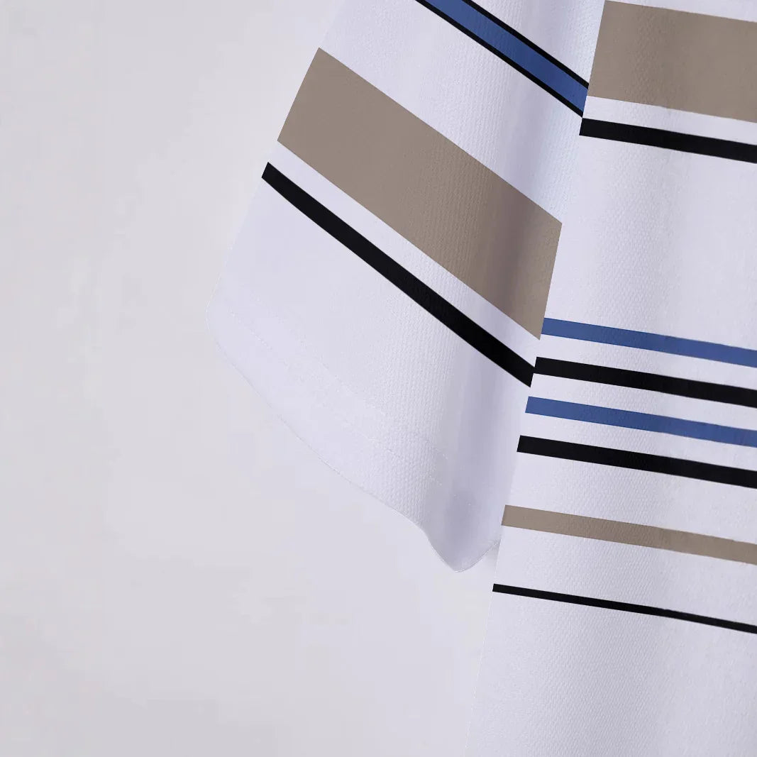 Close-up of white fabric with blue, black, and beige horizontal stripes and geometric pattern