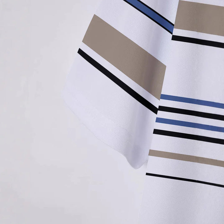 Close-up of white fabric with blue, black, and beige horizontal stripes and geometric pattern