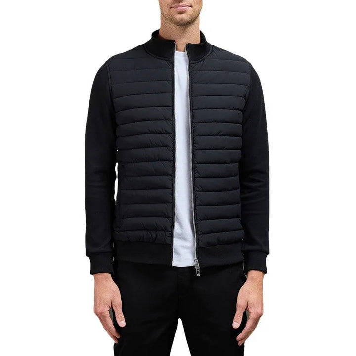 Man wearing black quilted bomber jacket with zip front and ribbed cuffs, paired with white t-shirt