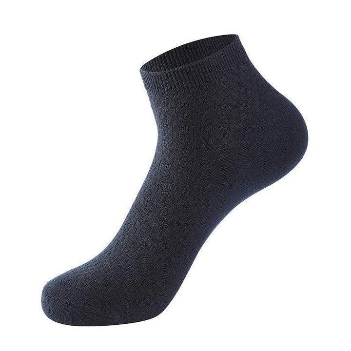 single navy blue ankle sock with textured knit pattern on white background