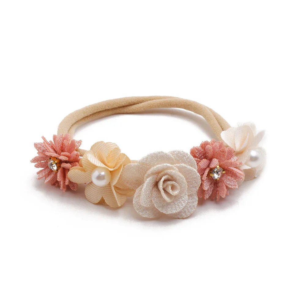 Beige and pink floral fabric hairband with pearl and rhinestone accents on white background
