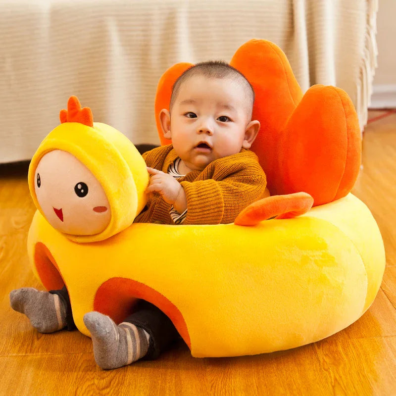 Baby sitting in a yellow plush duck-shaped chair on wooden floor indoors