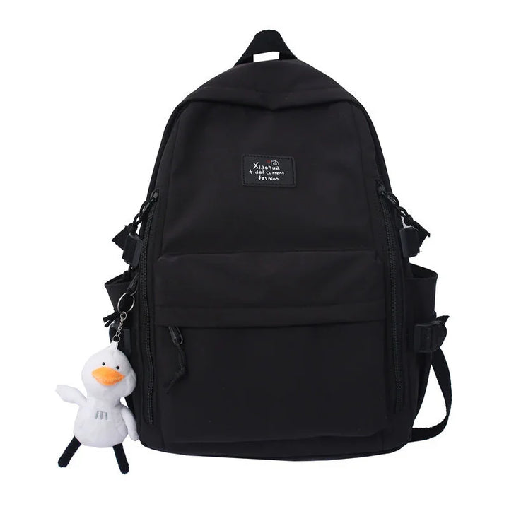 Black casual backpack with multiple zippered pockets and white duck plush keychain