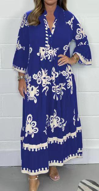 woman wearing long blue maxi dress with white floral patterns and 3/4 sleeves