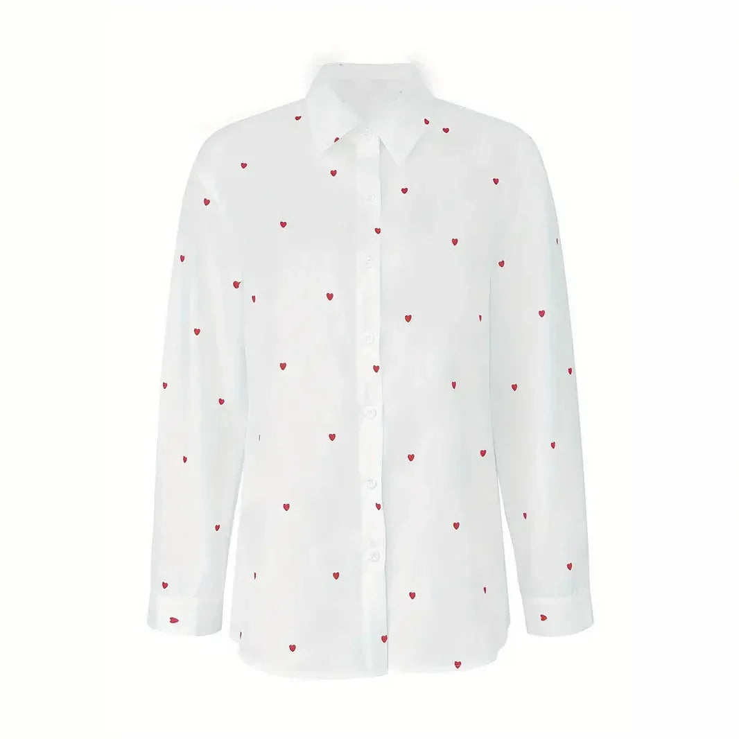 White long-sleeve button-up shirt with small red heart print pattern