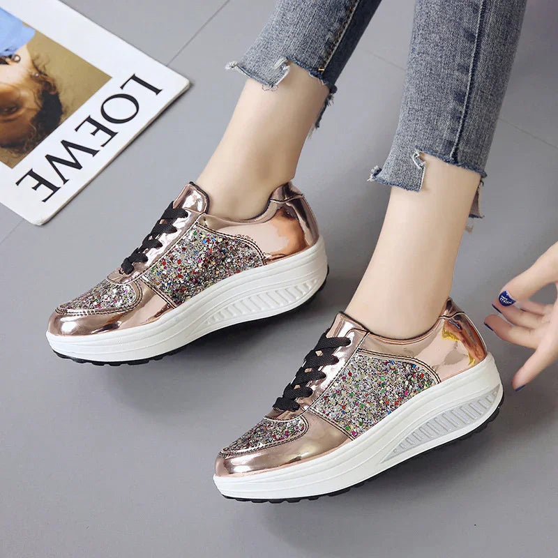 Rose gold platform sneakers with glitter panels and black laces worn with frayed hem jeans