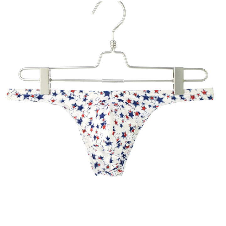 White men's thong underwear with red and blue star pattern on metal hanger