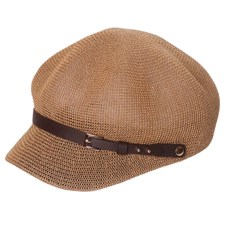 Light brown woven newsboy cap with a dark brown leather strap and buckle detail