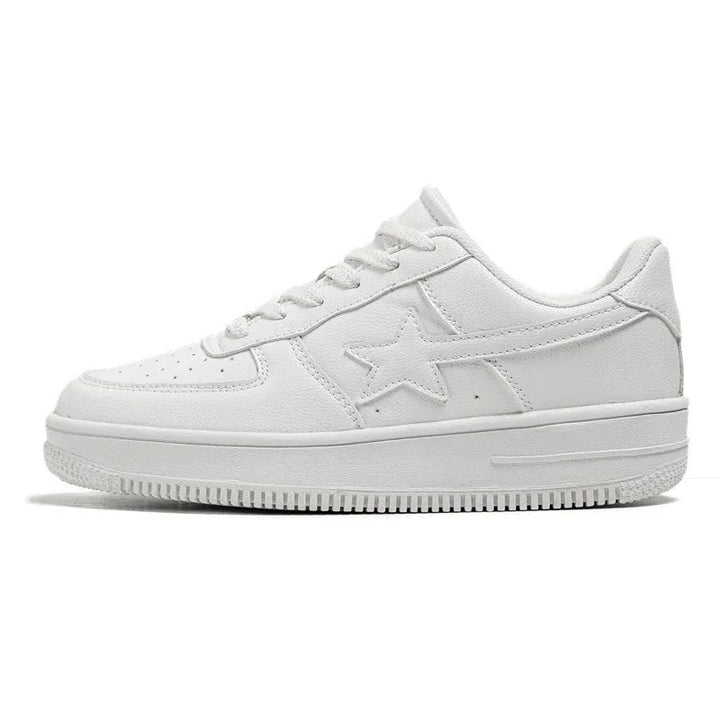 All-white low-top sneaker with star design on side and textured sole