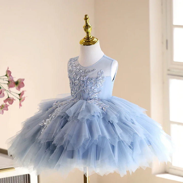 Light blue embroidered tulle flower girl dress on mannequin with layered ruffles