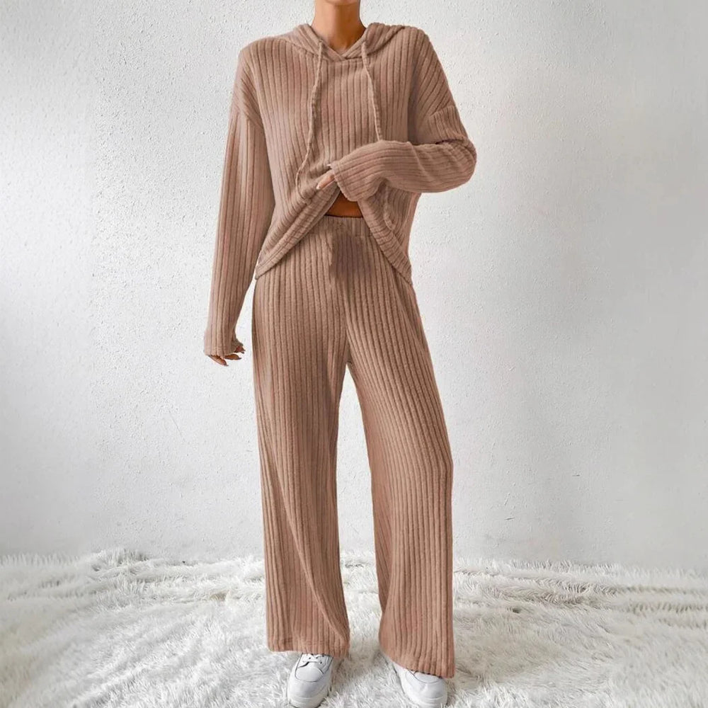 Woman wearing beige ribbed knit hoodie and wide-leg pants loungewear set with white sneakers